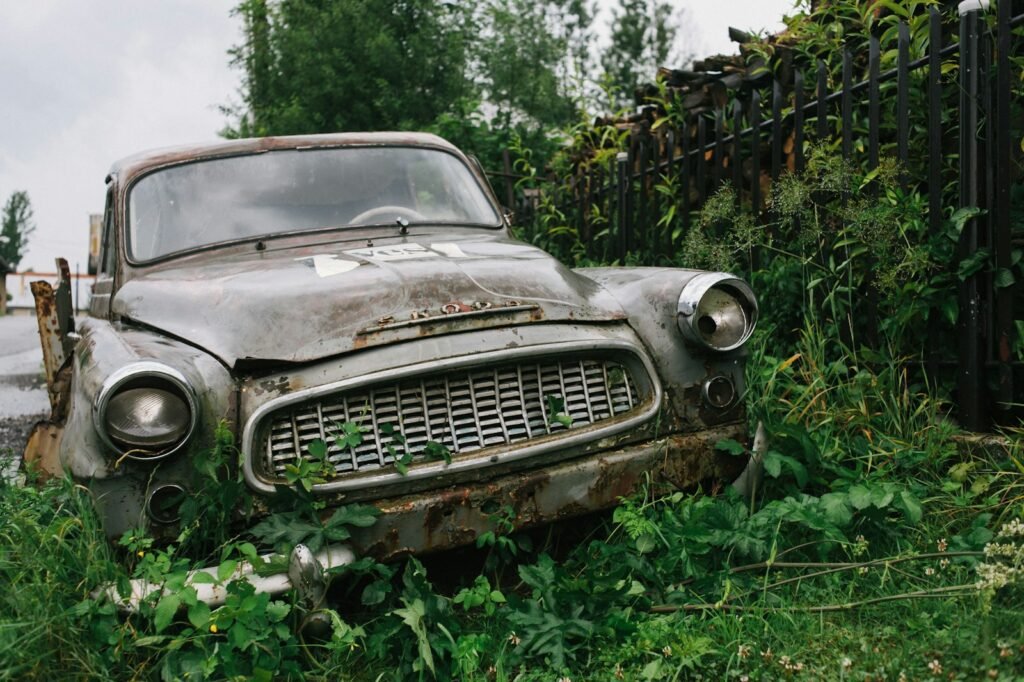 vintage brown car on green grass field during daytime